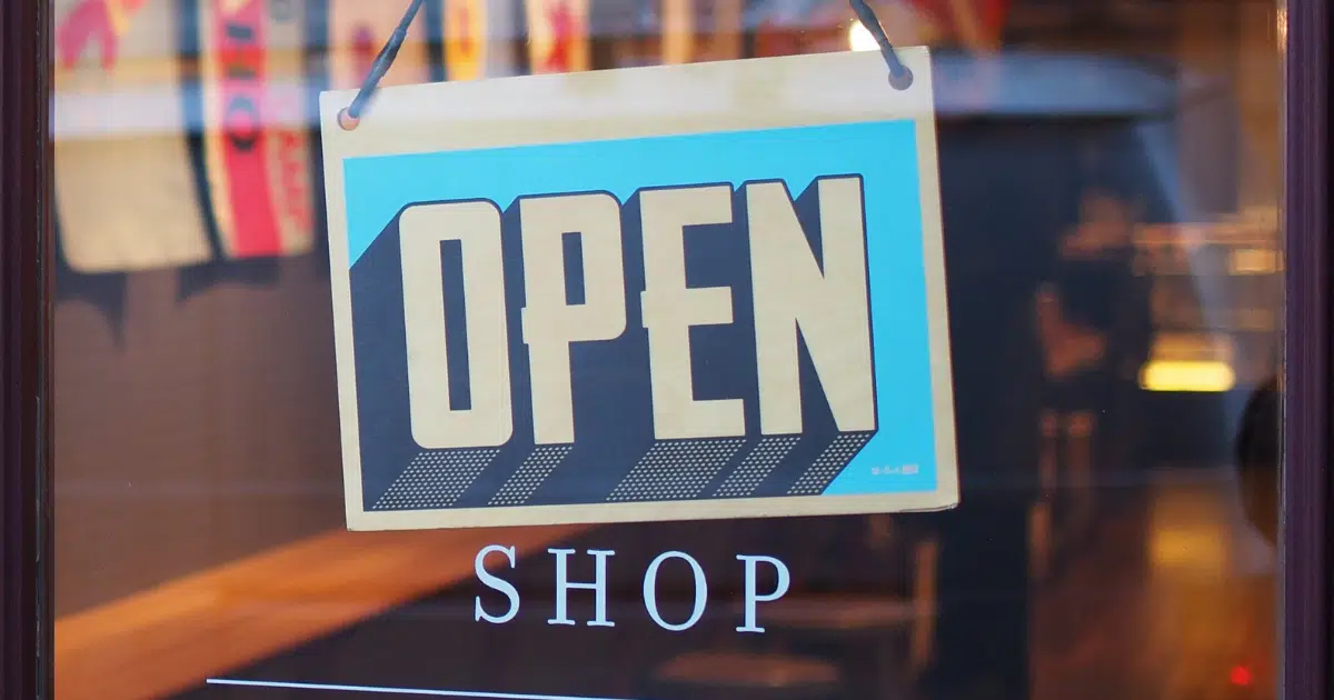 an 'open' sign hangs on the door of a retail store