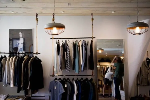 a retail clothing store with shirts hanging on racks