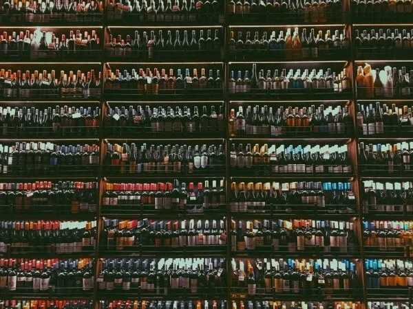 Large wall of beer, wine, and other alcoholic beverage at a liquor store.