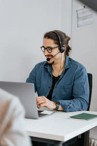 a POS company customer support representative speaks to a client on the phone
