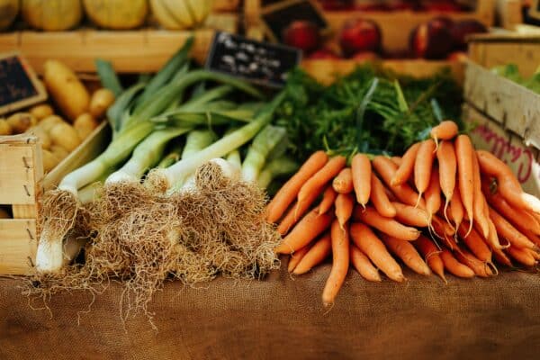 a photo showing carrots and leeks from a local farm