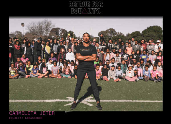 an image from Nike's Equality Campaign showing Carmelita Jeter standing on a football field in front of children and families