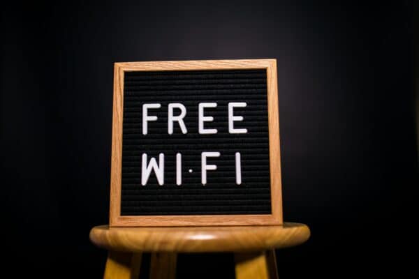 a letterboard sign reading "FREE WIFI" sits on top of a wood stool
