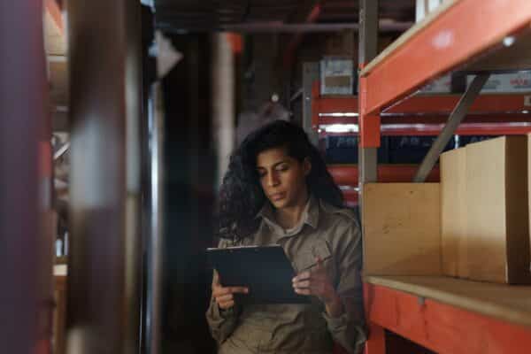 a small business owner looks over their slow-moving inventory