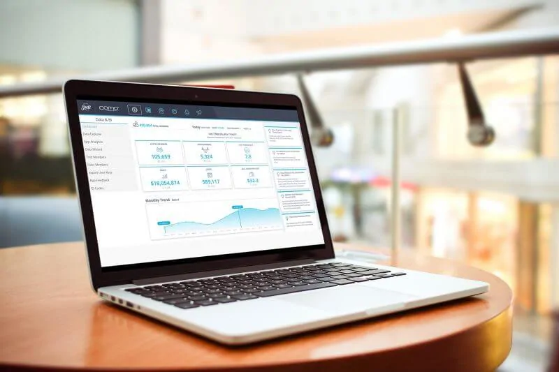 a laptop with Como Sense customer relationship management platform software open on the screen