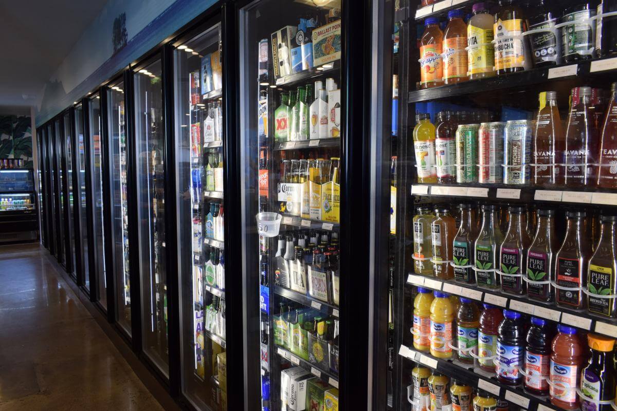 Gift Shop and Market A row of refrigerated drinks in a gift store market