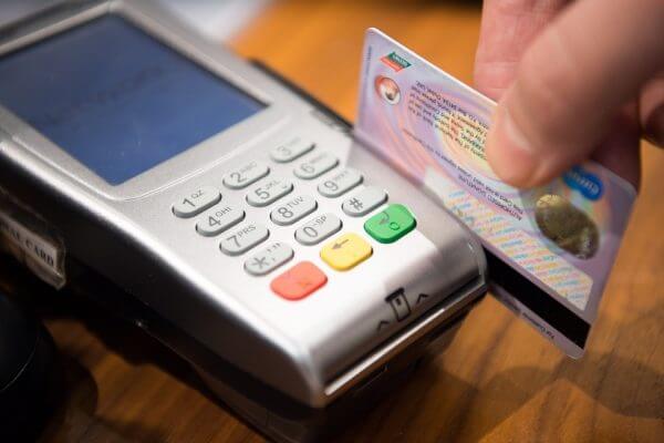 a customer swipes a credit card through a credit card machine