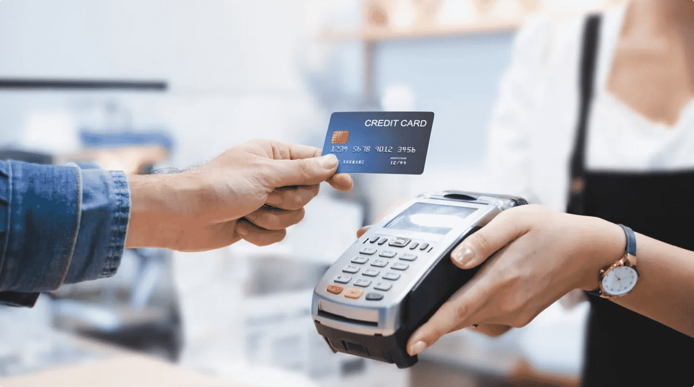 Image showing a cashier accepting a credit card payment.