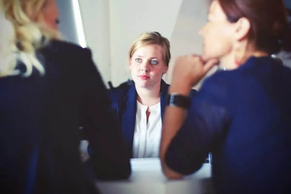 a retailer listens to customers sitting across the table