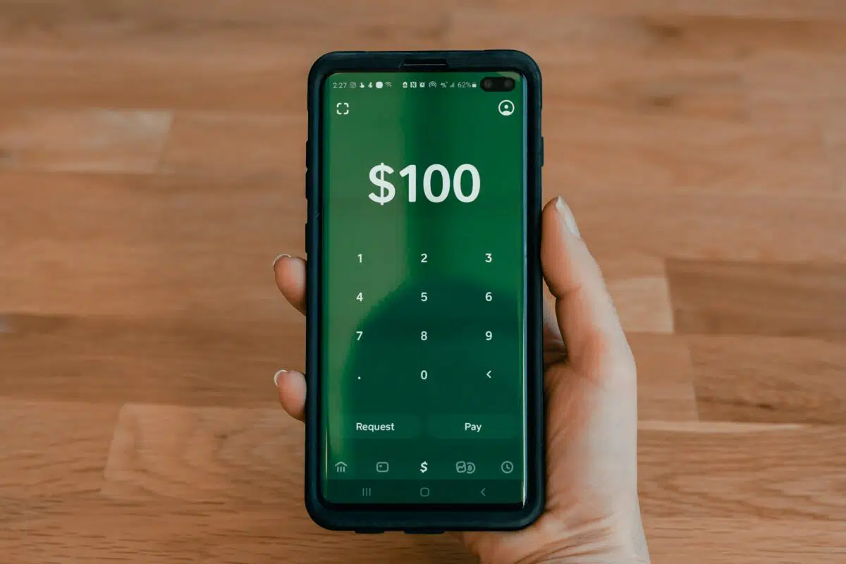a person holds their smart phone with CashApp open