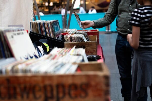 customers look at vinyl records at a street shop