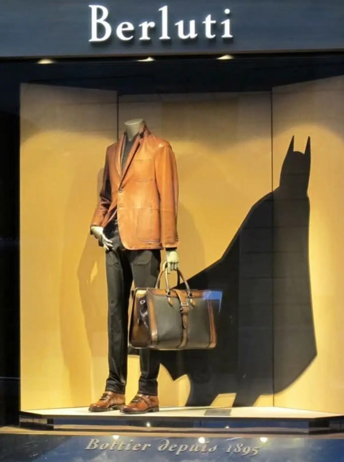 a window display from Berluti menswear showing a Batman theme