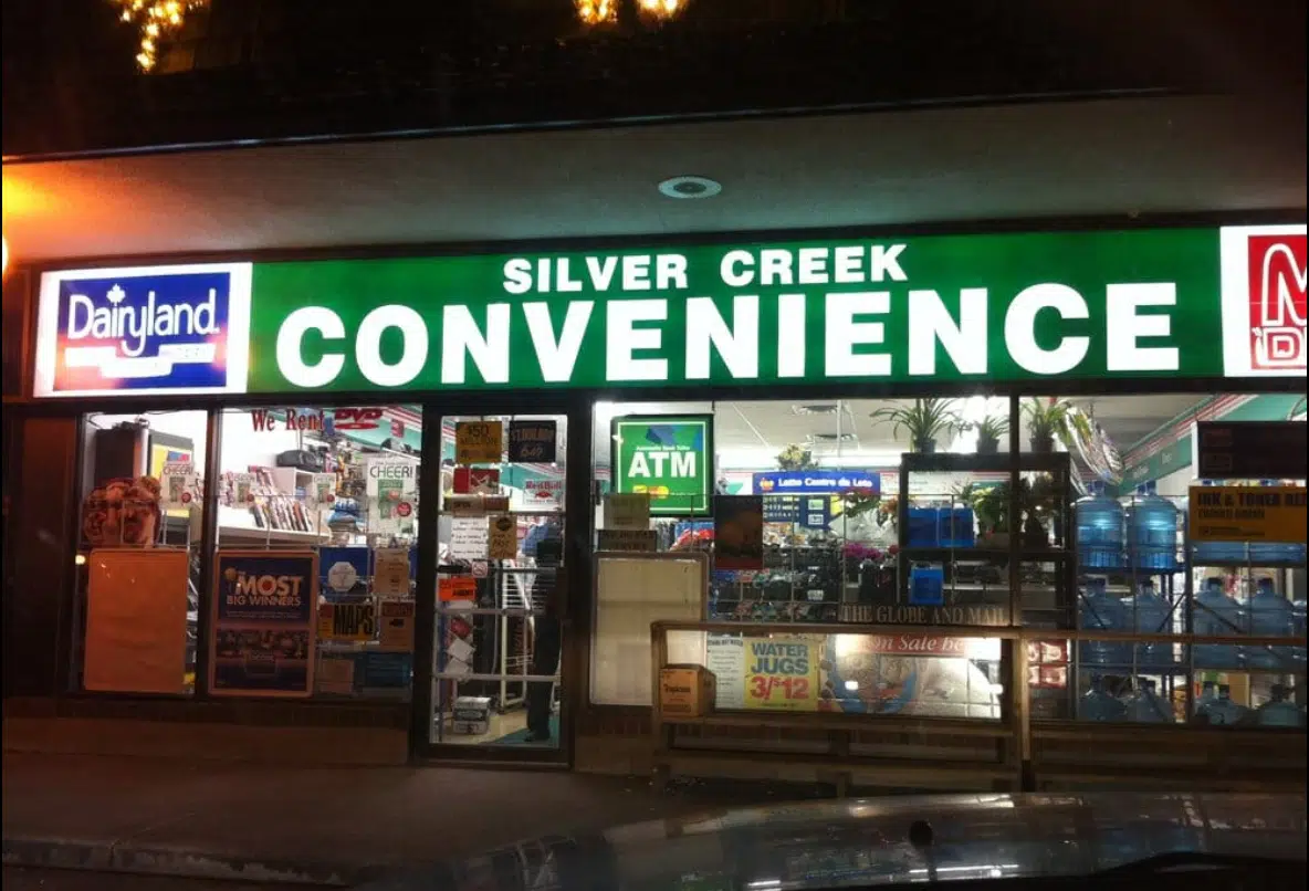 the exterior of a convenience store showing window display of items for sale