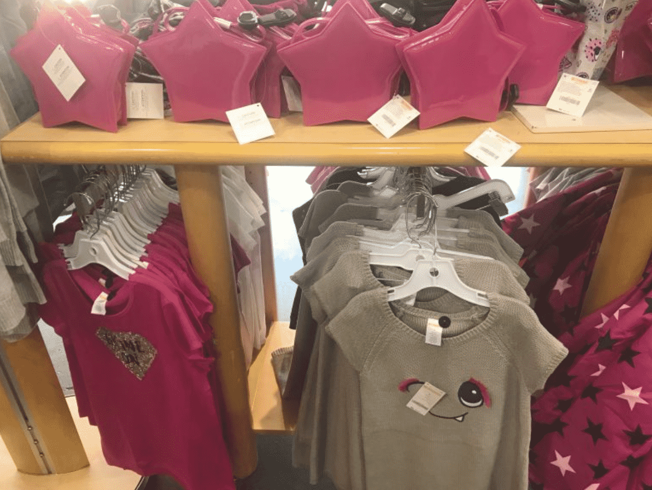 Display from Gymboree which features a range of shirts and sweaters with a matching handbag as an example of retail store layout