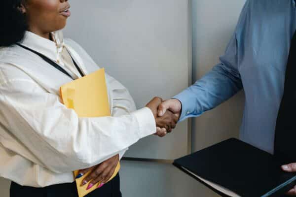 a business owner shakes hands with a bank lender