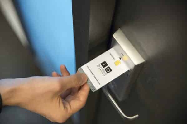 an employee uses a key card to enter a secure door