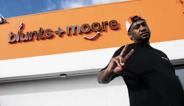 dispensary owner Tucky Blunt is pictured in front of his blunts + moore dispensary