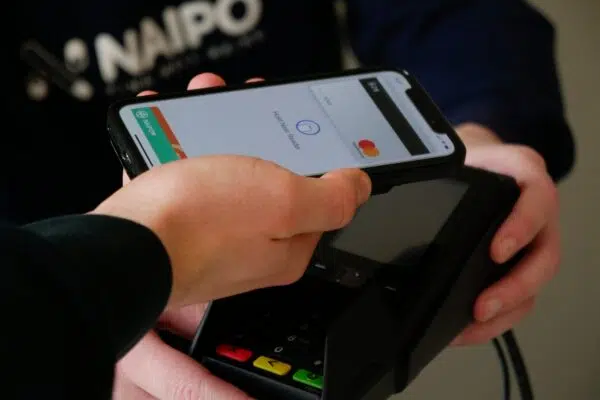 a customer makes a contactless payment from their smart phone