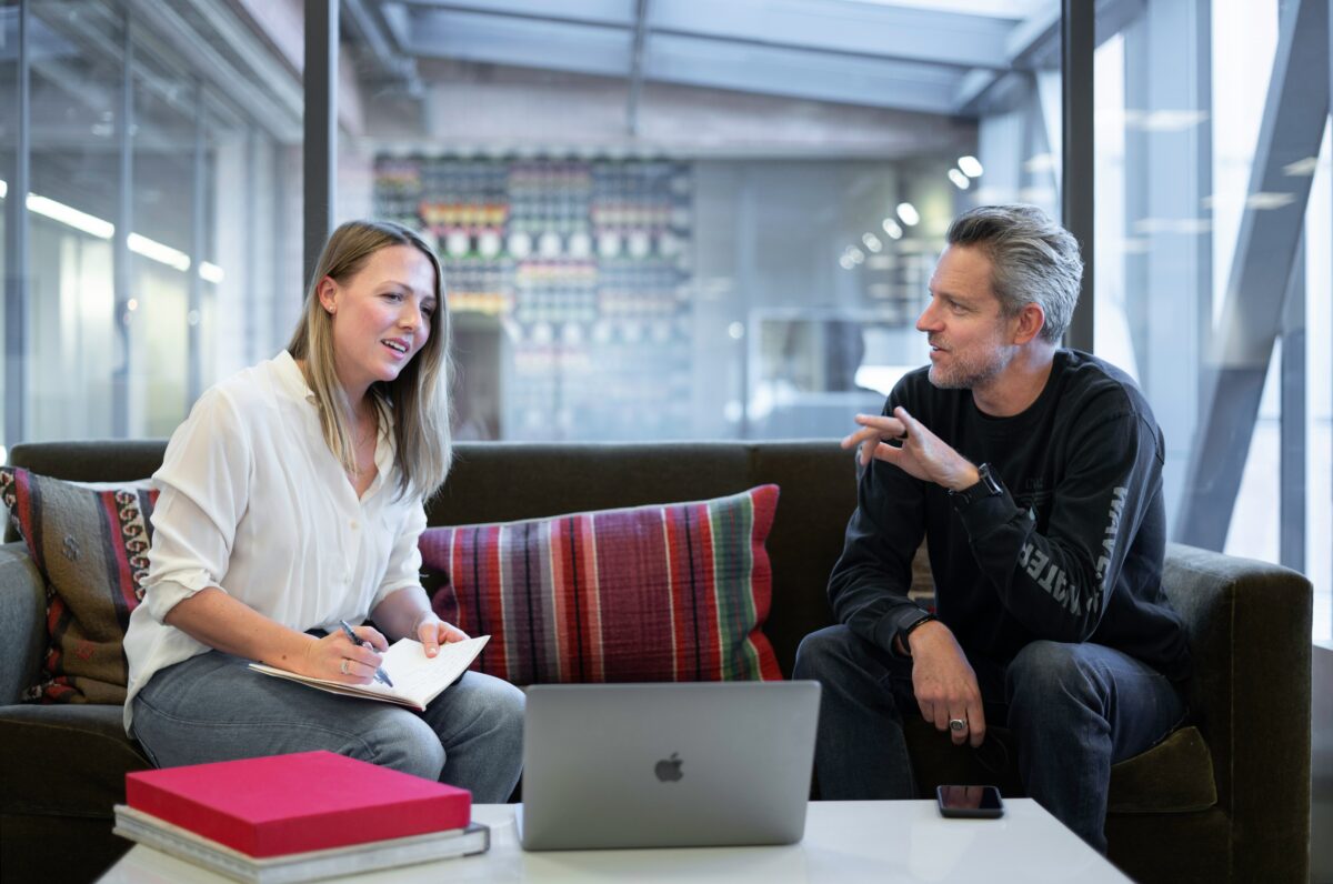 Two people discussing a business plan together in a conference room