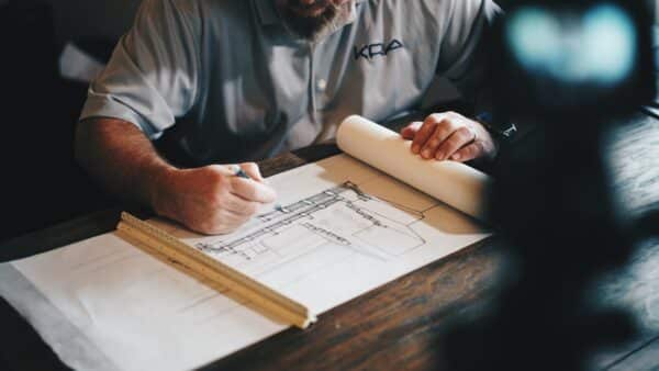 a photo showing a dispensary owner looking over architectural blueprints for a marijuana retail business