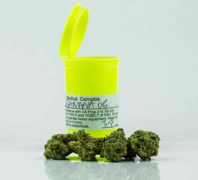 a photo of a cannabis canister with a marijuana bud in front of it