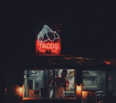 a photo showing a taco truck with a neon light