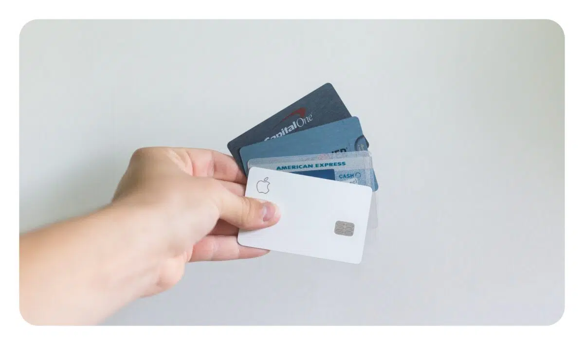 a person holds up different types of credit cards