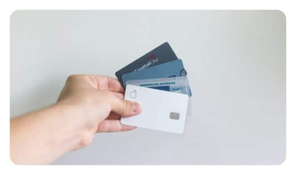 a photo showing someone holding different credit cards