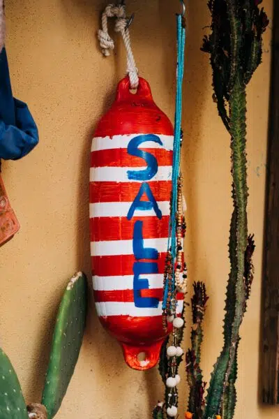 a buoy in a liquor store painted with the word 'SALE'