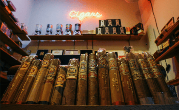 different cigar brands are displayed on a tobacco shop counter