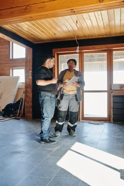 two construction workers look over smoke shop blueprints