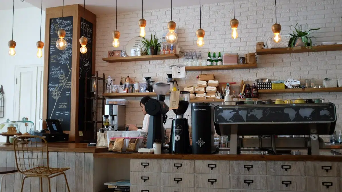 a coffee shop counter with a barista in the background