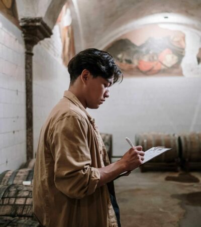 a wine cellar worker looks over stock