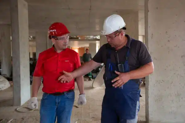 two dispensary construction engineers discuss building plans