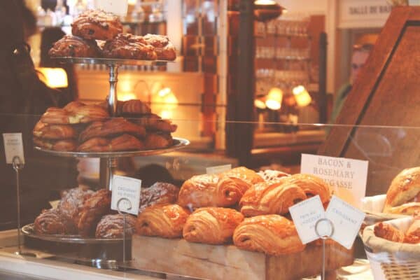 baked goods are displayed in a bakery window