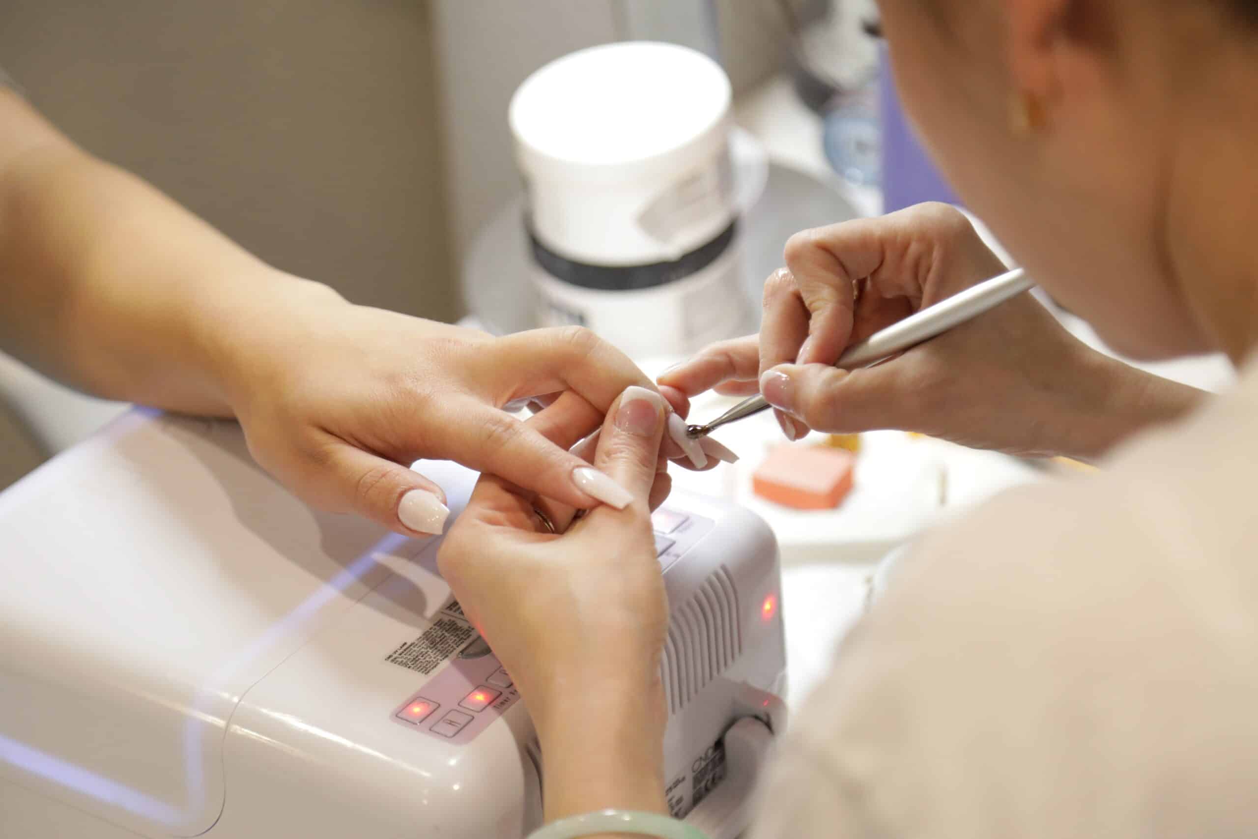 a customer gets their nails done in a salon