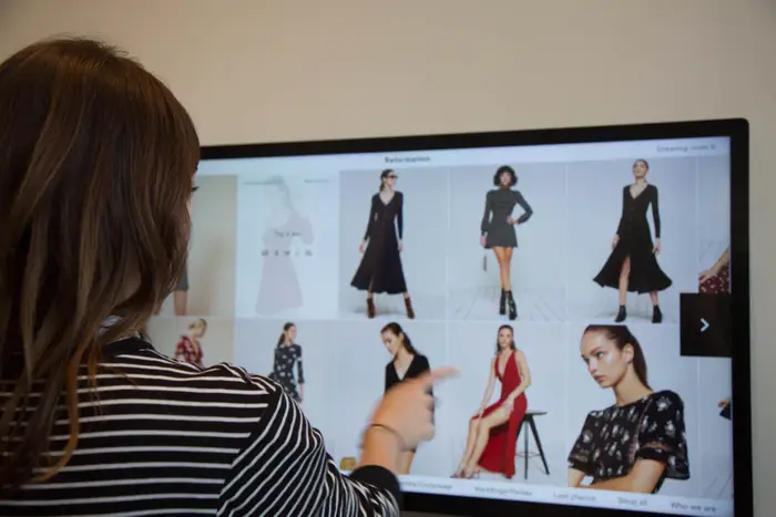 a shopper at reformation uses their virtual augmented in-store experience