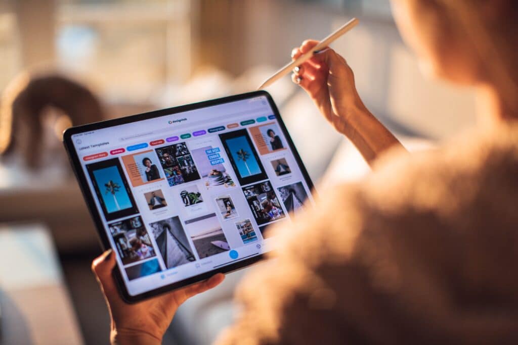 a website designer uses a tablet to work on eCommerce merchandising