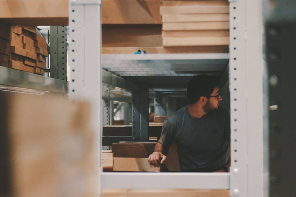 a retail employee uses rfid to locate items in a warehouse