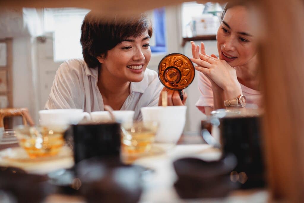 customers hold a piece of glass in a gift shop