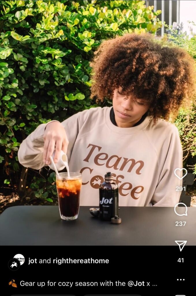 an example of social retail from Jot coffee's Instagram page showing a woman sitting outside pouring milk into her coffee drink
