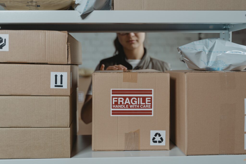 a retail employee looks through boxes of inventory