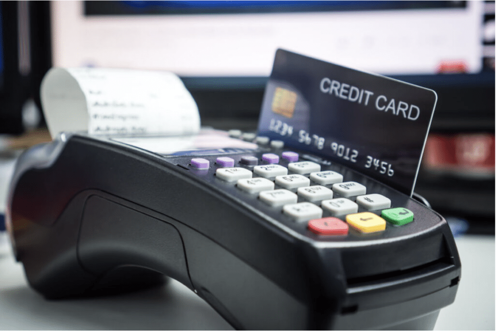 Image showing a credit card being processed in a retail store. 
