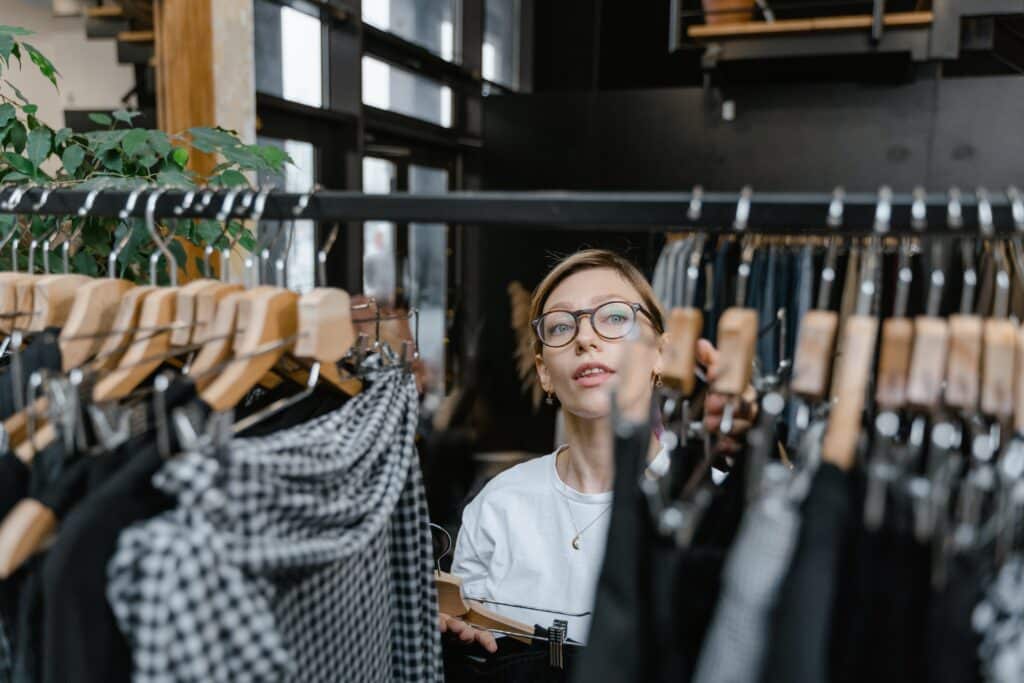 an employee in a clothing store works on visual merchandising for the retail environment