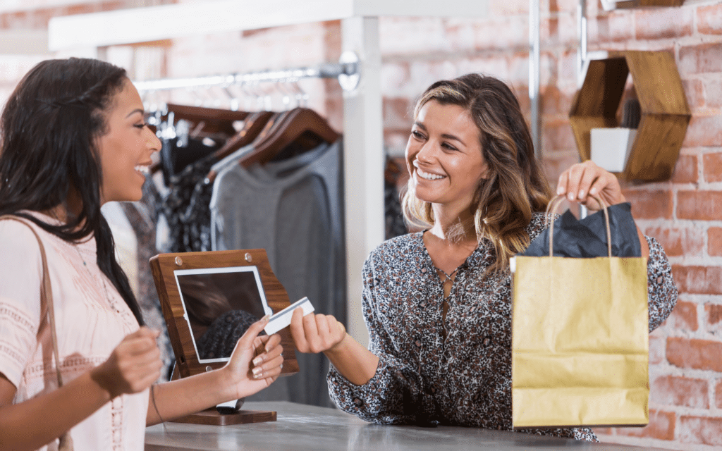 a shopper pays for a clothing purchase with a gift card