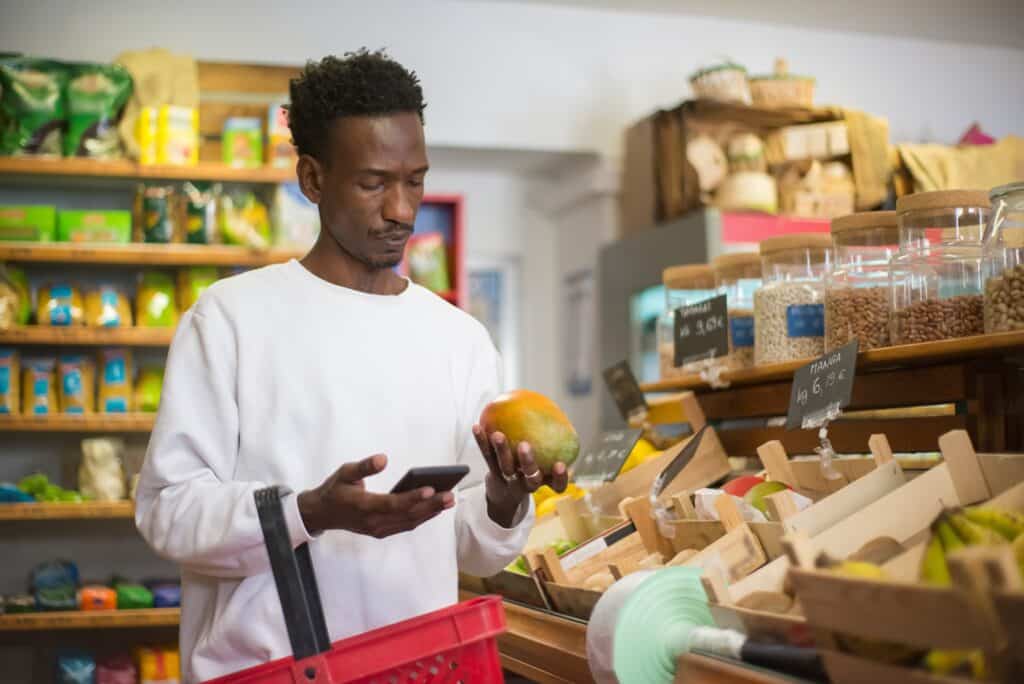 a shopper uses Scan & Go technology in a grocery store