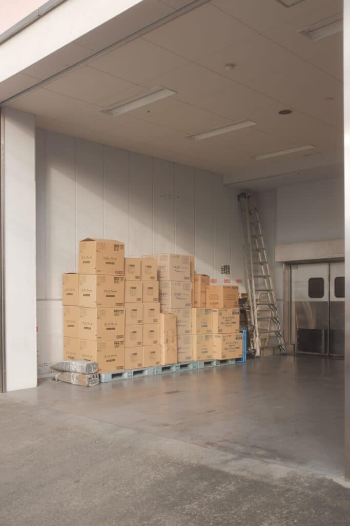 boxes of goods sit in a loading dock of a retailer