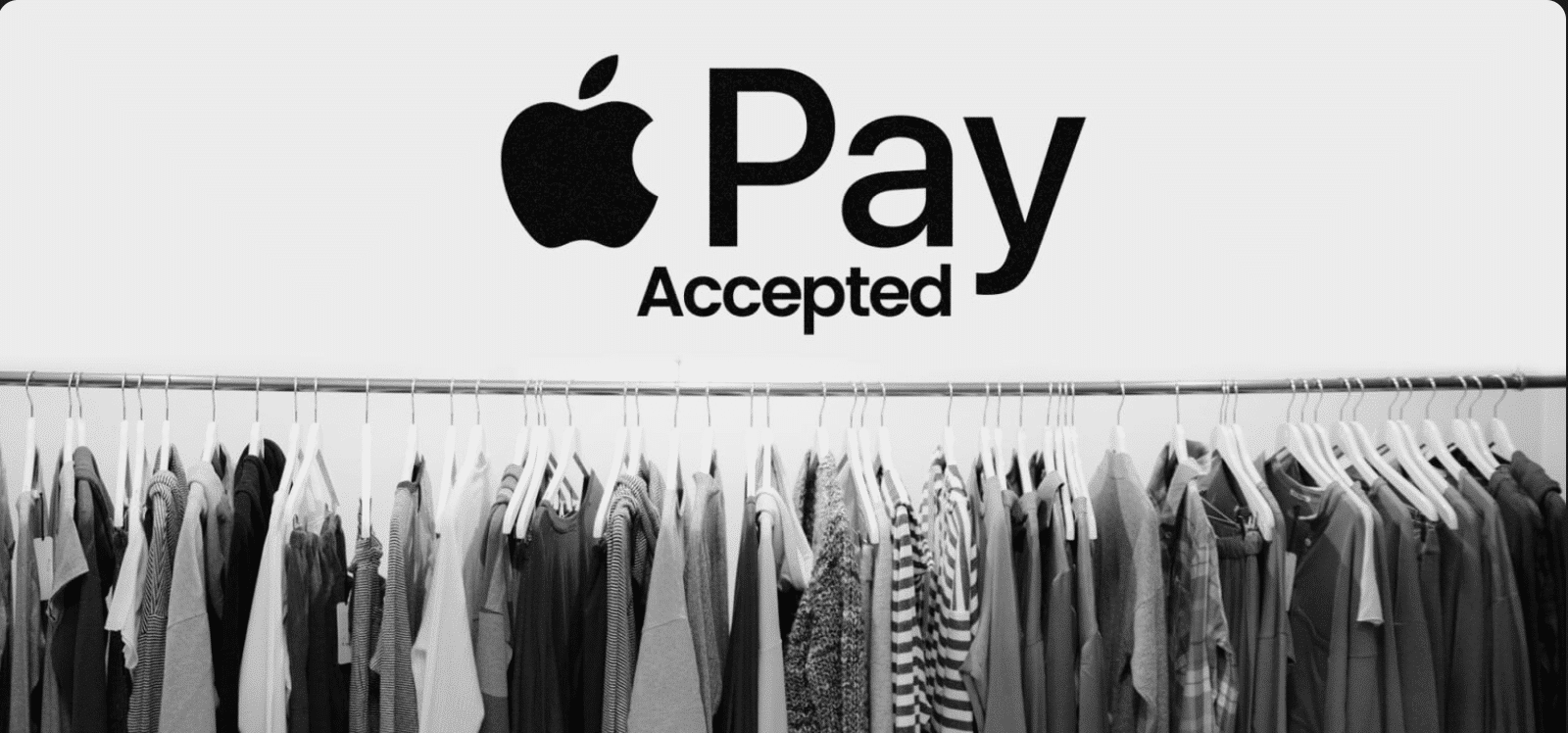 Picture showing a clothing retail store and an sign that it accepts Apple Pay as a payment. 