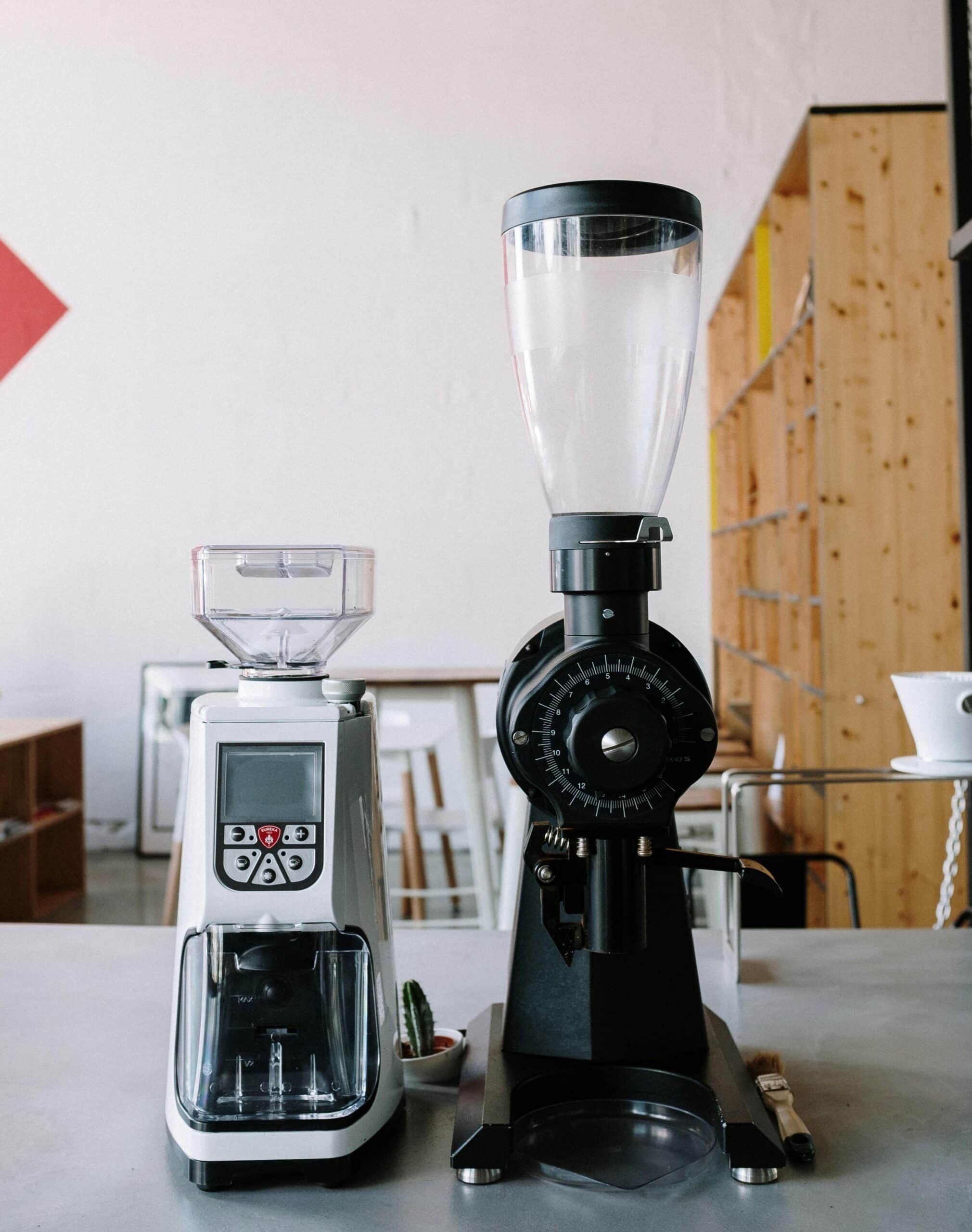 an espresso grinder and a coffee grinder sit on a counter