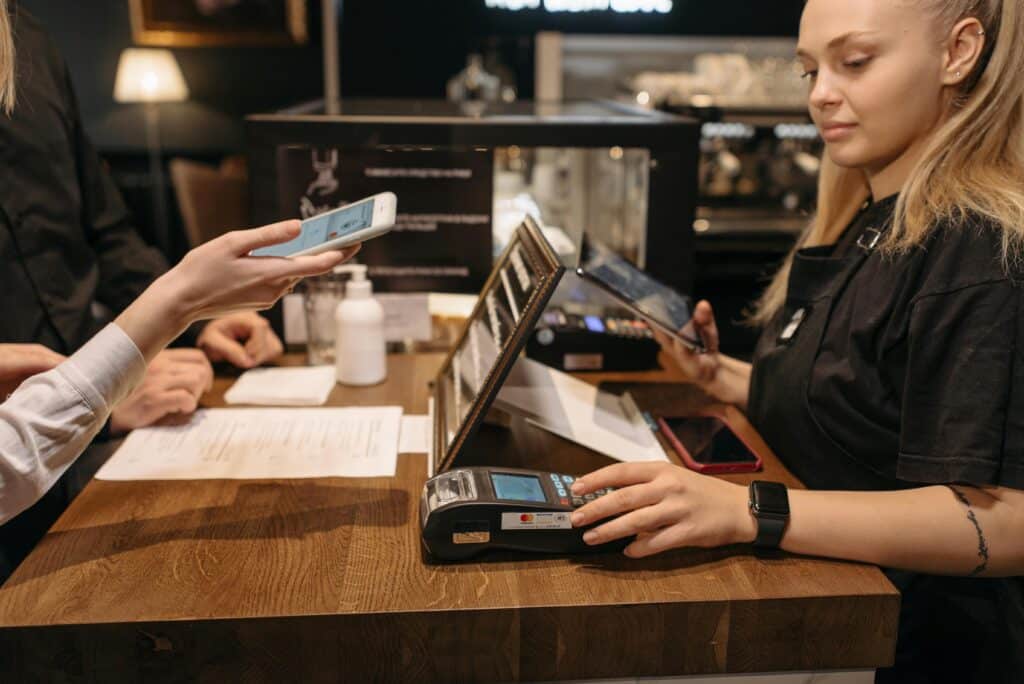 a person pays for an item at a countertop payment terminal